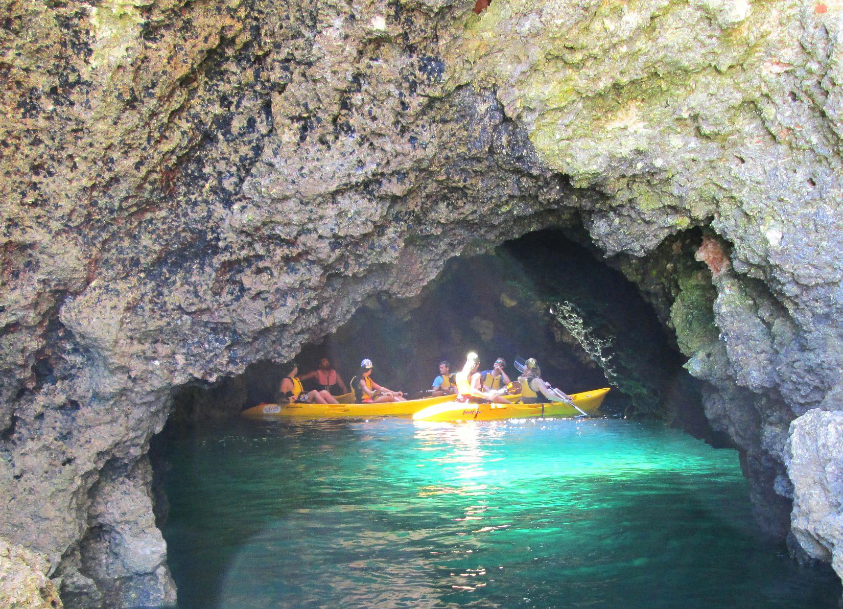 Enter the caves by kayak