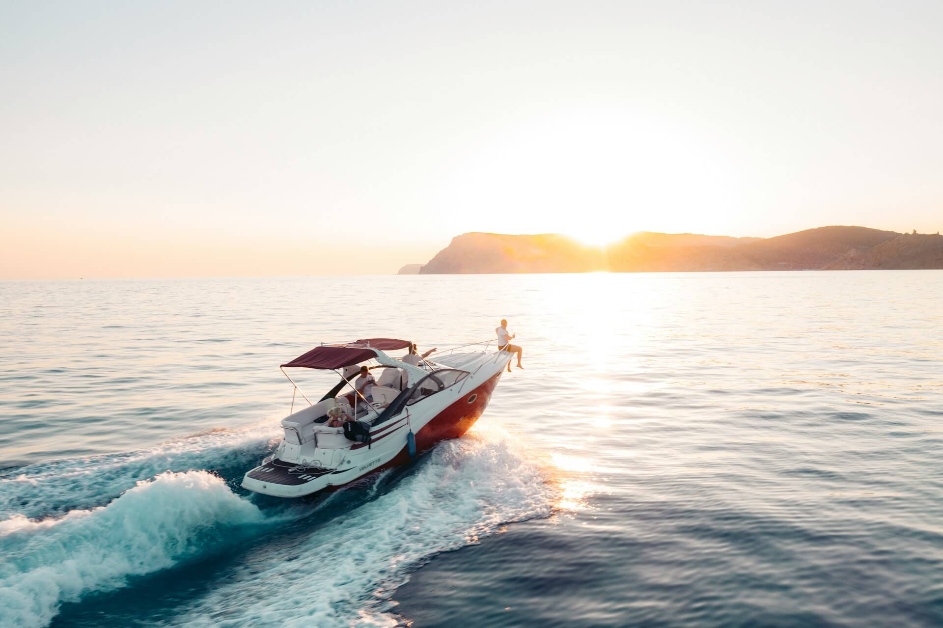 yacht cruising to sunset