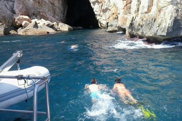 People swimming near the caves in Denia