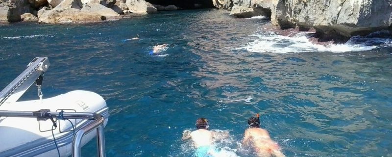People swimming near the caves in Denia