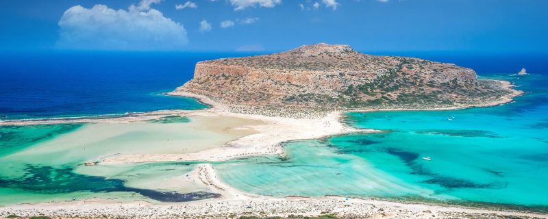 Balos,Lagoon,On,Crete,Island,,Greece.,Tourists,Relax,And,Bath