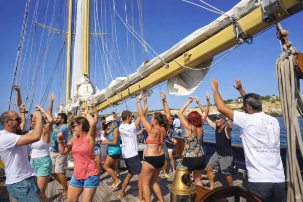 People dancing on a wooden sailing boat in Vilamoura