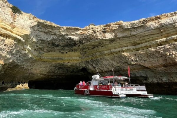 Catamaran sailing towards Benagil Cave during Christmas season.