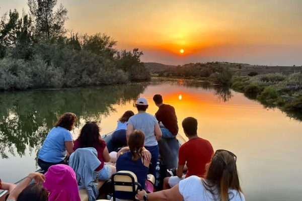 People on a boat on the Arade river close to silves enjoying a golden sunset