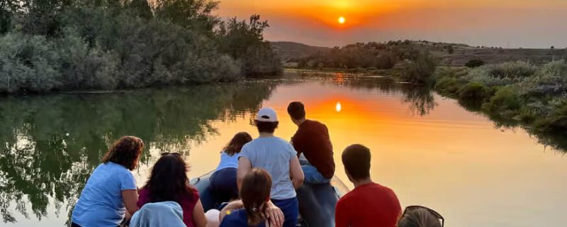People on a boat on the Arade river close to silves enjoying a golden sunset